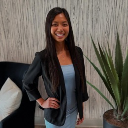 a woman smiling wearing a suite a woman smiling wearing a suite