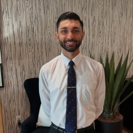 a man smiling wearing a suite a man smiling wearing a suite