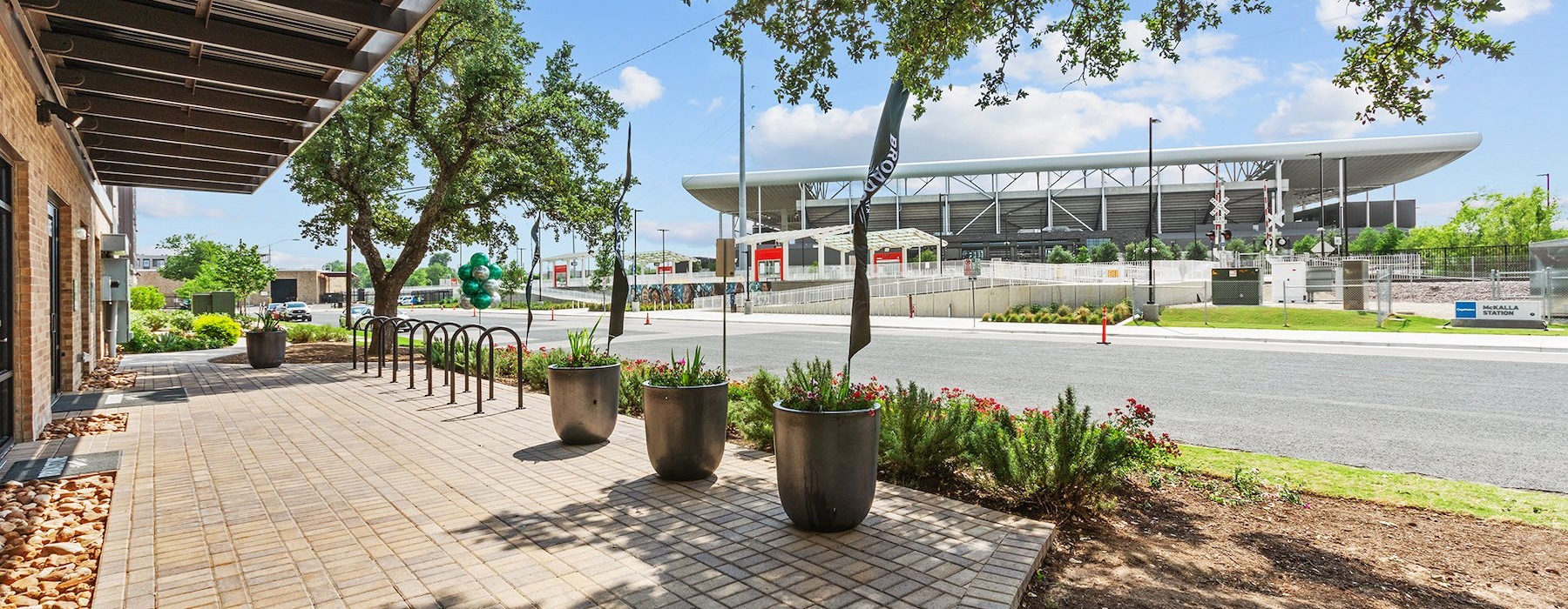 a street with a sidewalk and buildings